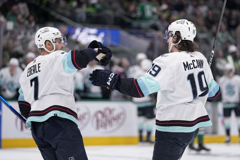 Seattle Kraken right wing Jordan Eberle (7) and left wing Jared McCann (19) celebrate after McCann scored off the assist from Eberle and Jamie Oleksiak in the second period of an NHL hockey game against the Dallas Stars, Tuesday, March 21, 2023, in Dallas. (AP Photo/Tony Gutierrez)