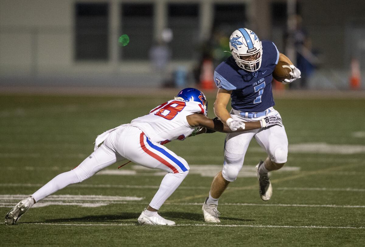 Corona del Mar's Colin Pene is tripped up during a Sunset League game against Los Alamitos at Davidson Field on Thursday.