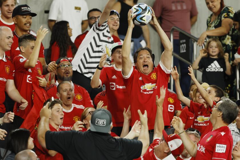 San Diego, CA - July 25: A fan catches the ball that was kicked into the stands during the Manchester United - Wrexham match at Snapdragon Stadium on Tuesday, July 25, 2023. (K.C. Alfred / The San Diego Union-Tribune)