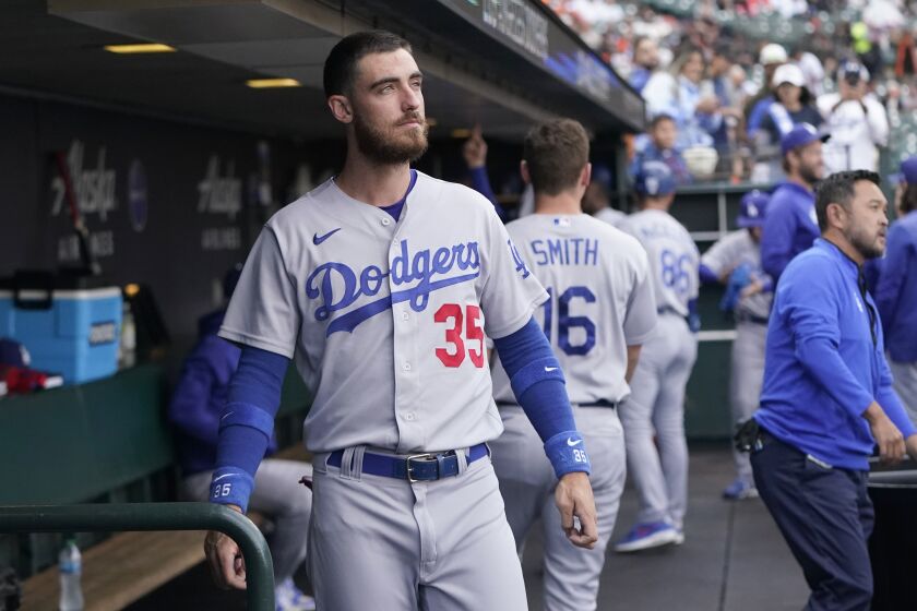 FILE - Los Angeles Dodgers' Cody Bellinger stands in the dugout before the team's baseball game against the San Francisco Giants in San Francisco, Aug. 2, 2022. The Dodgers didn't tender Bellinger a contract on Friday, Nov. 18, making the 2019 National League MVP a free agent. (AP Photo/Jeff Chiu, File)