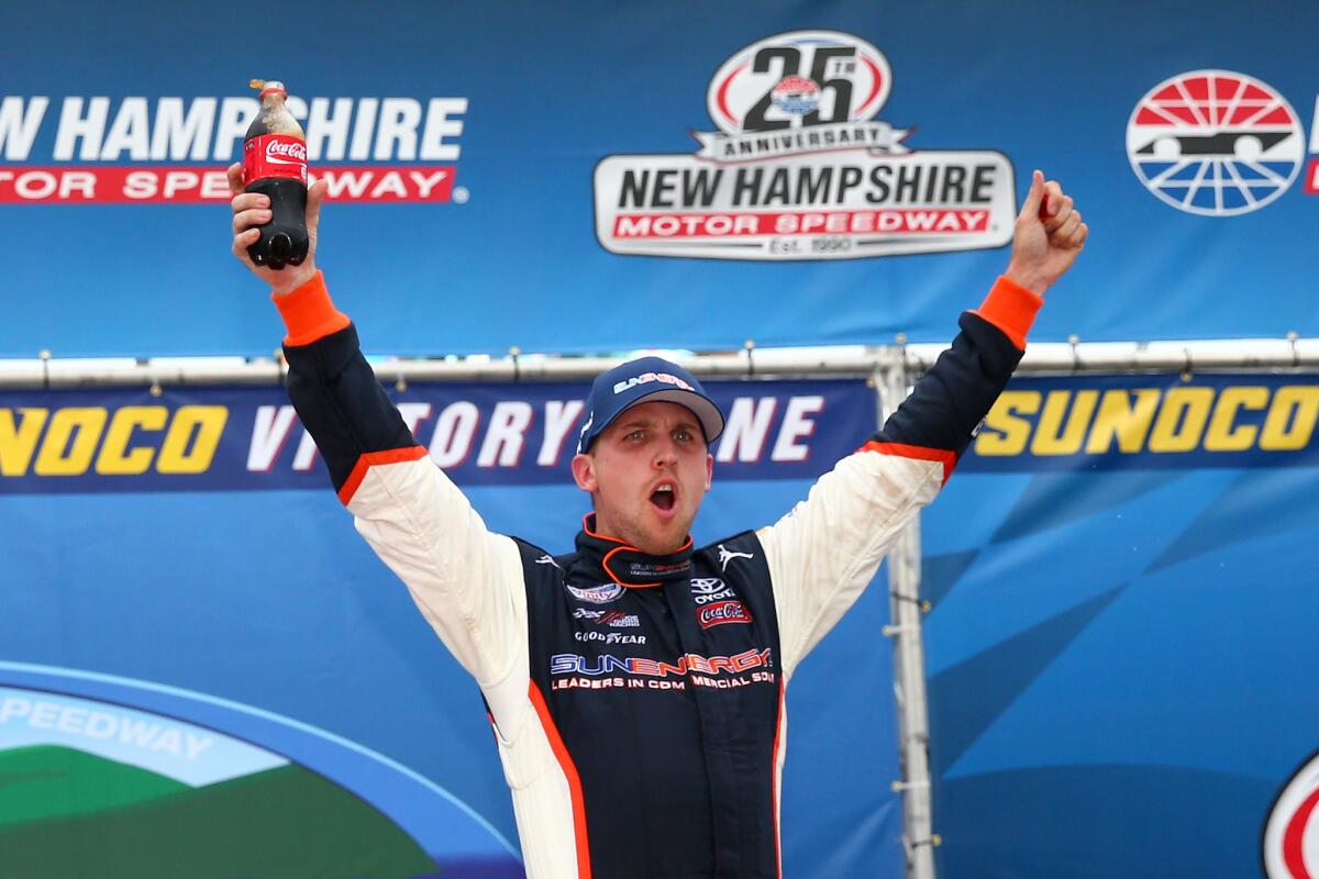 NASCAR driver Denny Hamlin celebrates in Victory Lane after winning the Xfinity Series Lakes Region 200 at New Hampshire Motor Speedway on Saturday.