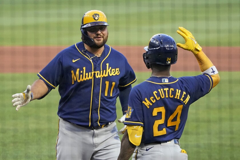 Milwaukee Brewers' Rowdy Tellez (11) celebrates with Andrew McCutchen after hitting a three-run home run off Pittsburgh Pirates starting pitcher Roansy Contreras during the second inning of a baseball game in Pittsburgh, Friday, July 1, 2022. (AP Photo/Gene J. Puskar)