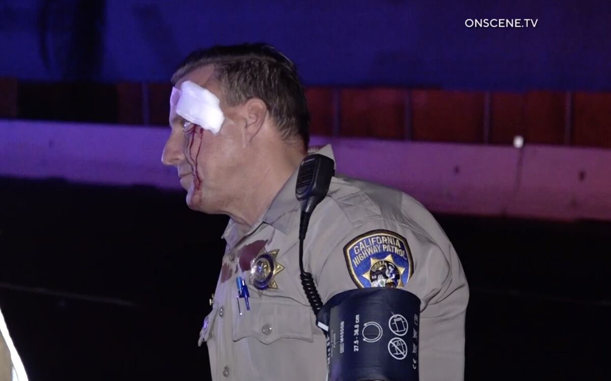 One of two California Highway Patrol officers who was injured in a crash Friday morning speaks with fellow officers after receiving medical treatment.