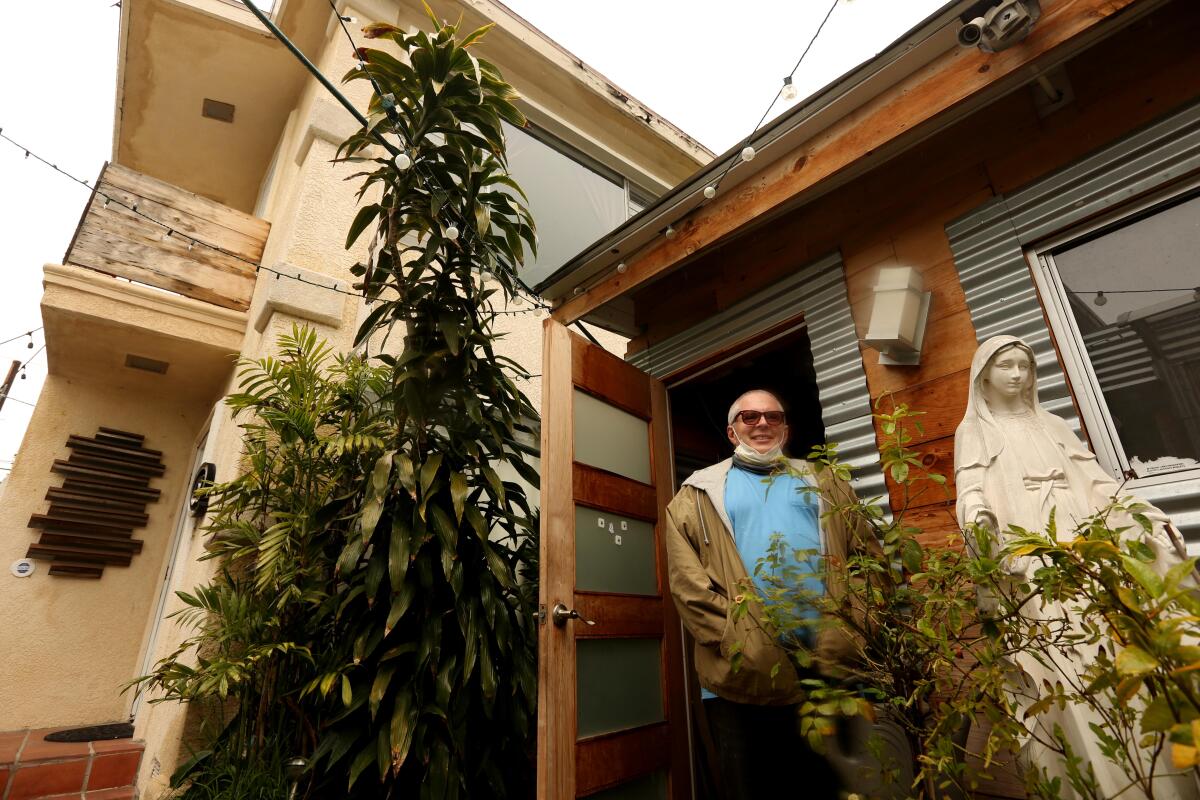 Darryl Marshak stands in the middle of his apartment complex in Mid-City Los Angeles.