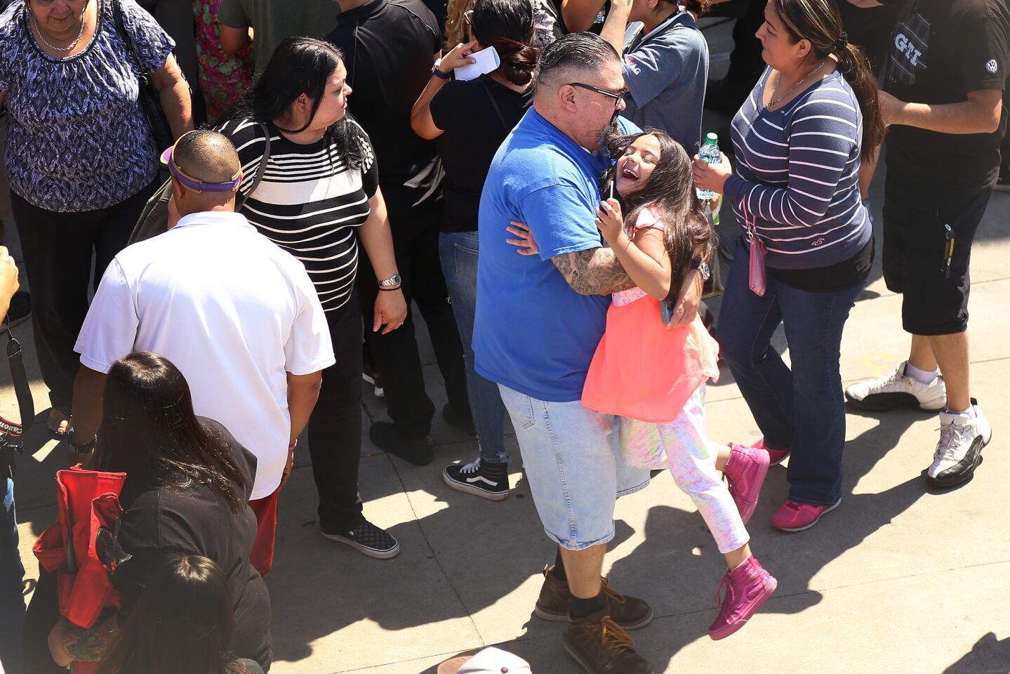 Parents are reunited with their children at Cajon High School after a school shooting at North Park Elementary School.