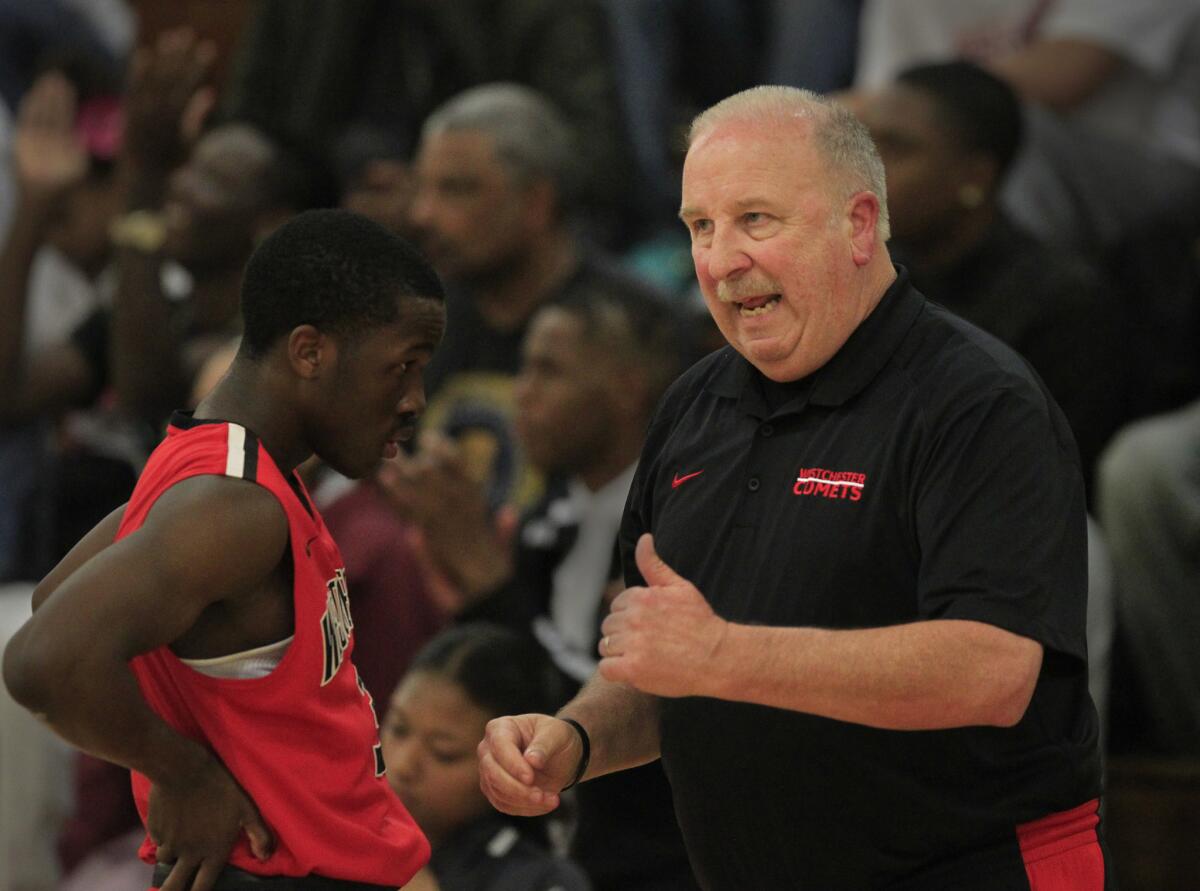 Westchester Coach Ed Azzam discusses strategy with one of his player during a Western League game against Fairfax.