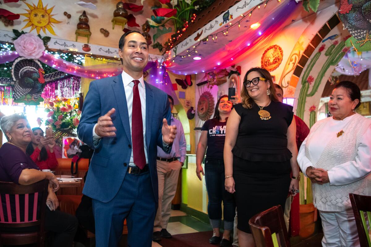 Presidential candidate Julian Castro talks with patrons at La Parrilla Restaurant