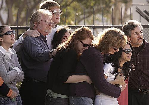 Family members and friends of Army Sgt. David J. Hart of Lake View Terrace watch as his body returns to Long Beach Airport from Iraq, where he and two other soldiers were killed Jan. 8 in a firefight north of Baghdad. His widow, Nicole, is second from right.