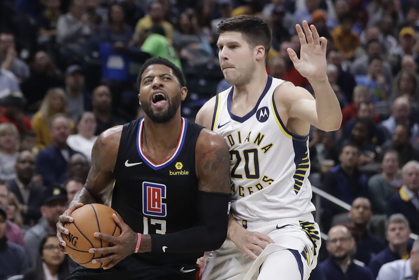 Clippers forward Paul George (13) drives to the basket against Pacers forward Doug McDermott (20) during the first half of a game Dec. 9.