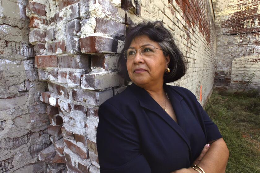 Supervisor Gloria Molina stands in front of the future home of La Plaza de Cultura y Arte, Thursday afternoon near historic O)lvera Street in downtown L.A. It's a Mexican-American cultural center that is expected to open in 2007.