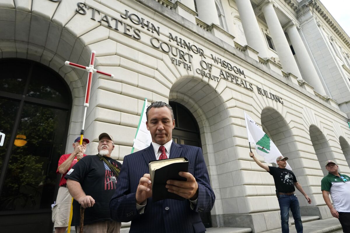 Tony Spell, pastor of the Life Tabernacle Church of Central City, La., waits outside the Fifth Circuit Court of Appeals in New Orleans, Monday, June 7, 2021. Spell, who flouted coronavirus restrictions last year, prepared Monday to ask the court to revive his lawsuit challenging the restrictions. (AP Photo/Gerald Herbert)