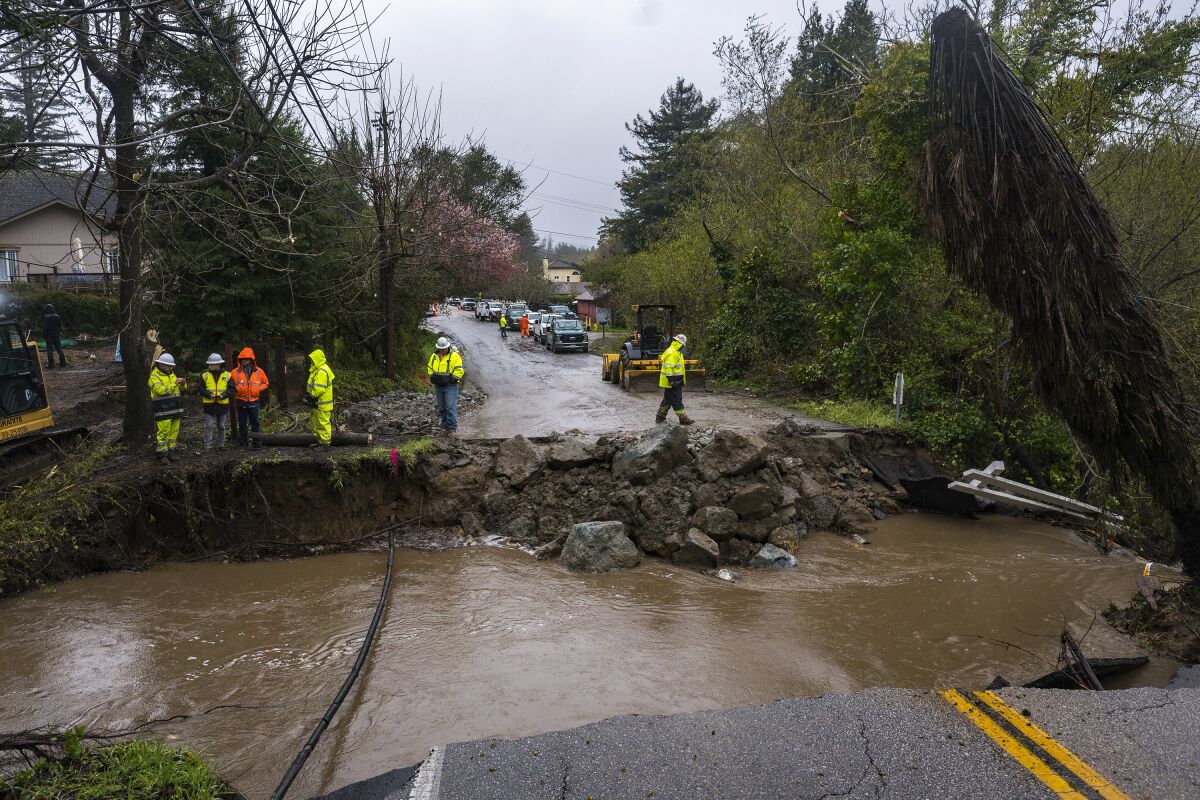 Crews assess storm damage, which washed out North Main Street in Soquel, Calif., Friday, March 10, 2023. (AP Photo/Nic Coury)