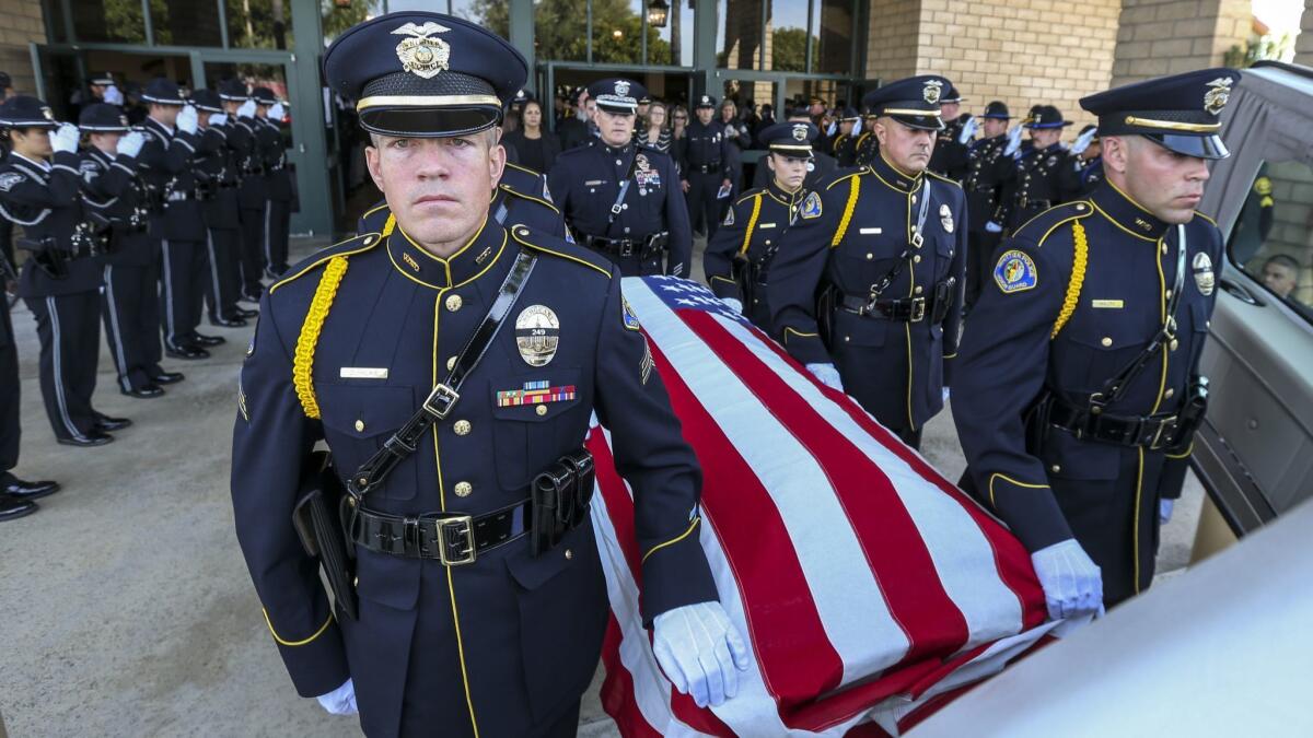 Whittier police officers escort the coffin of slain officer Keith Boyer at his funeral.