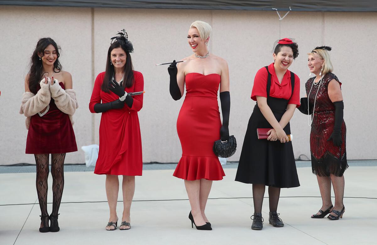 Women who dressed as Miss Scarlet forthe costume contest held before the stage performance of "Clue."
