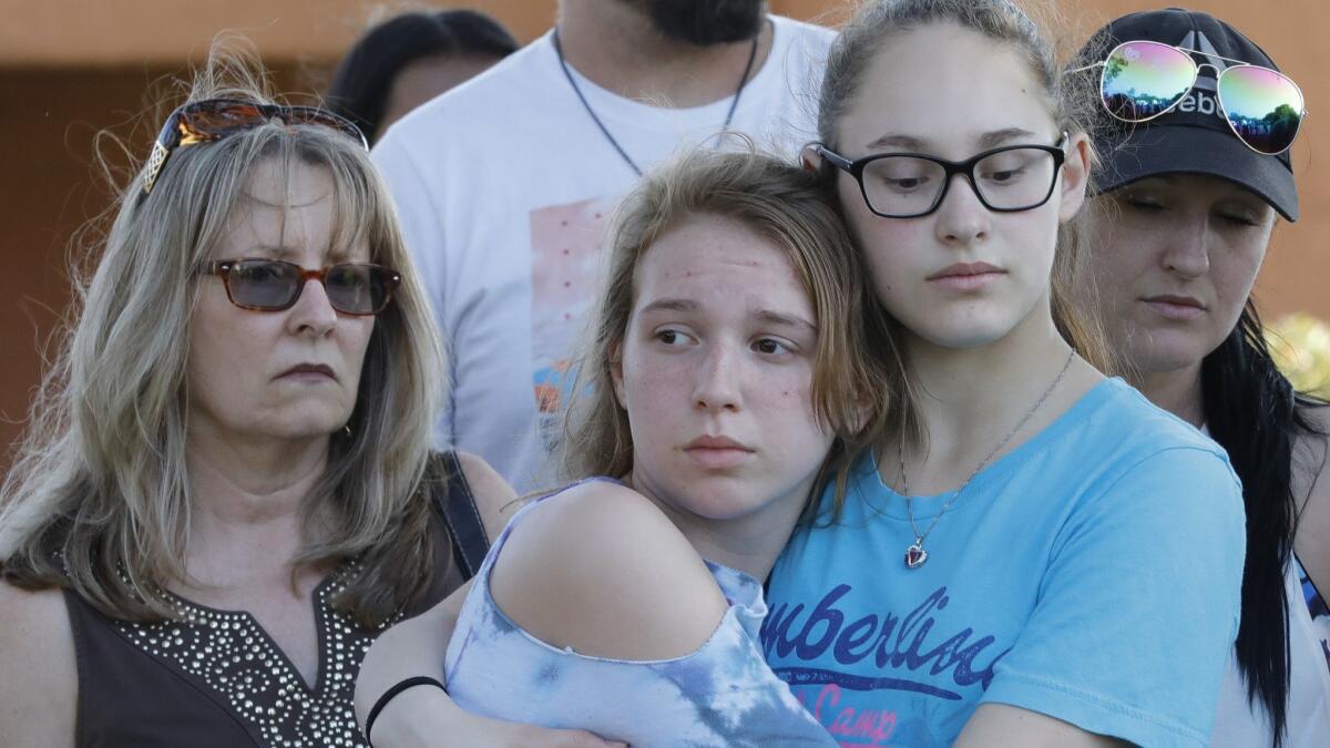 Friends and family attend a vigil held at the First Bank in Santa Fe, Texas, for the victims of a mass shooting at Santa Fe High School.