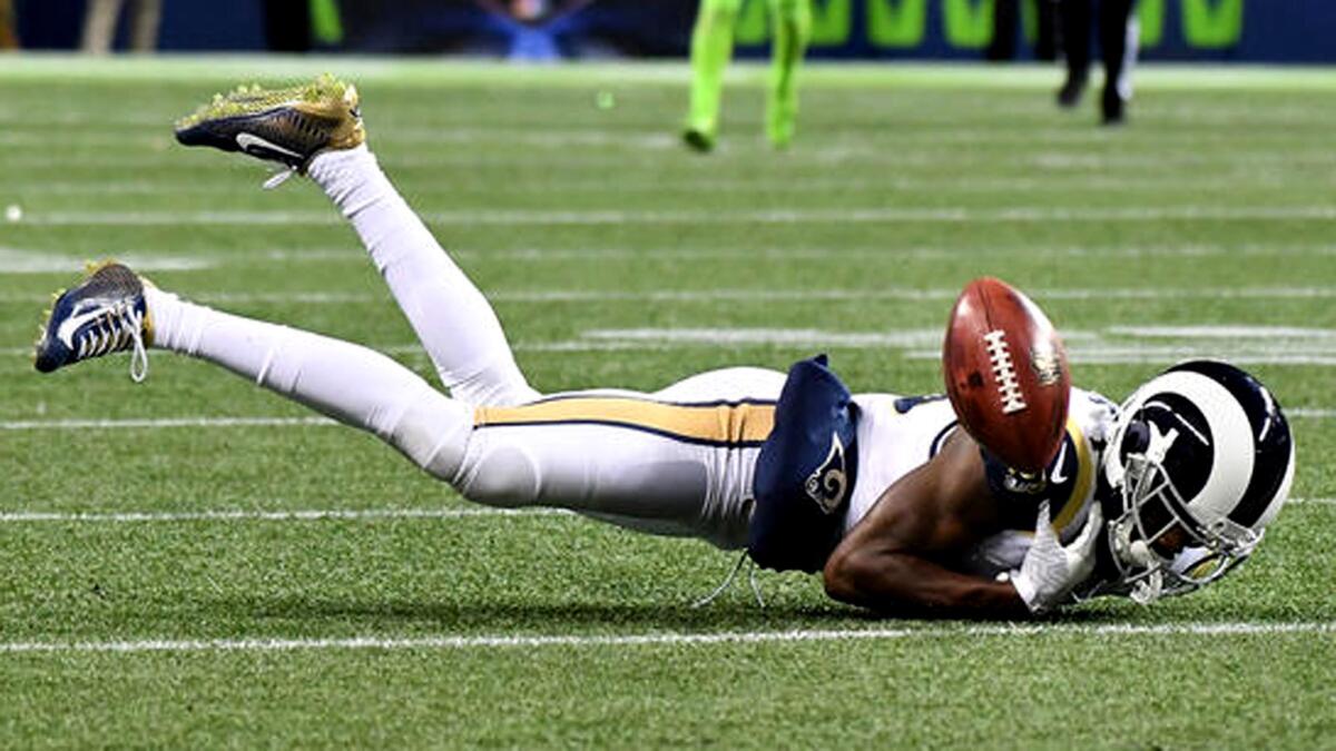 Receiver Michael Thomas drops a pass from punter Johhny Hekker as a fourth-down fake by the Rams fails in the second quarter of a game against the Seattle Seahawks on Dec. 15.
