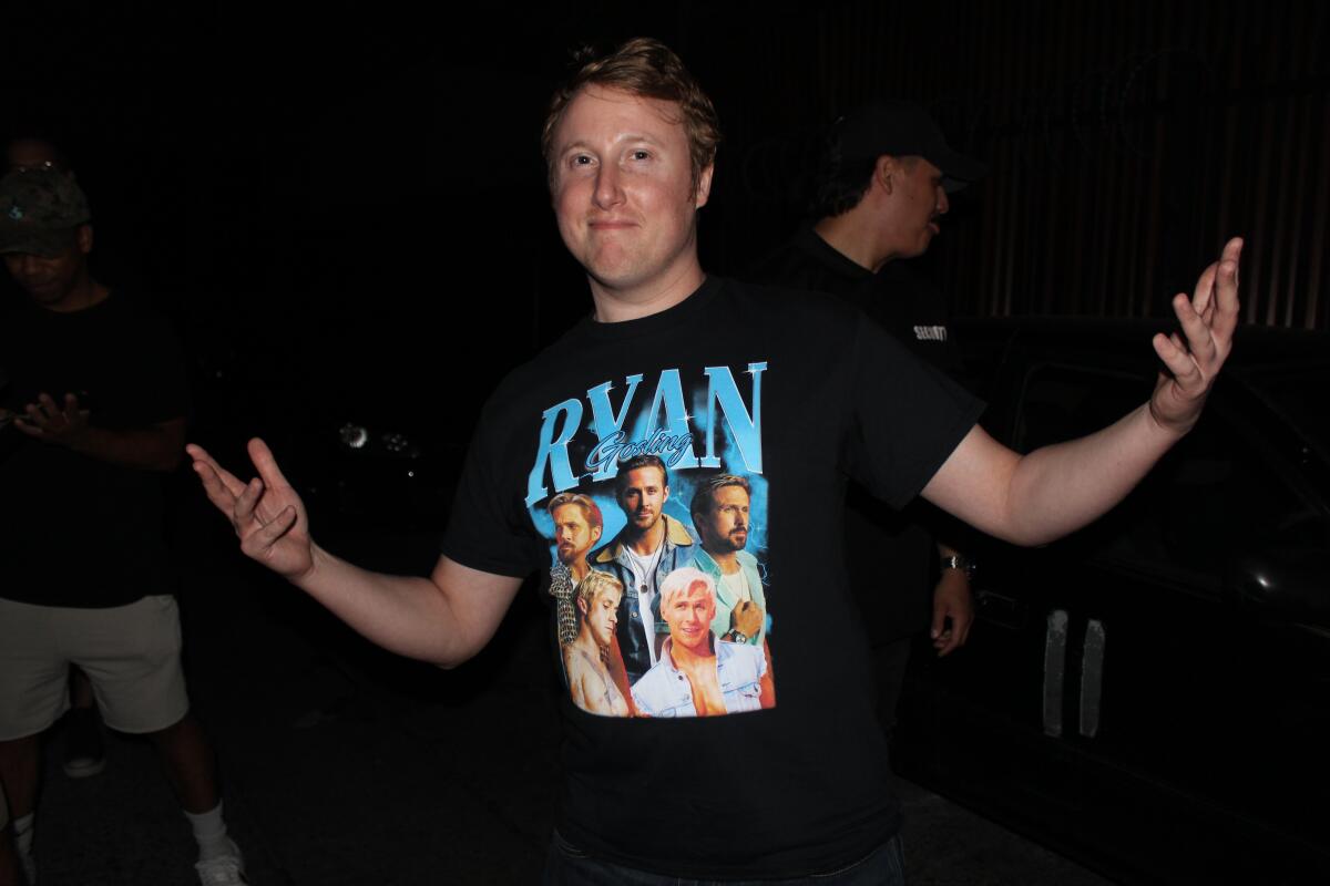 A man poses in a t-shirt featuring various images of actor Ryan Gosling.
