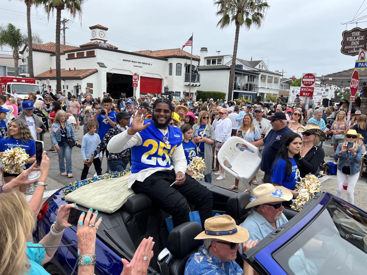 Desjuan Johnson rides on the back of a convertible during the Balboa Island Parade on June 4.