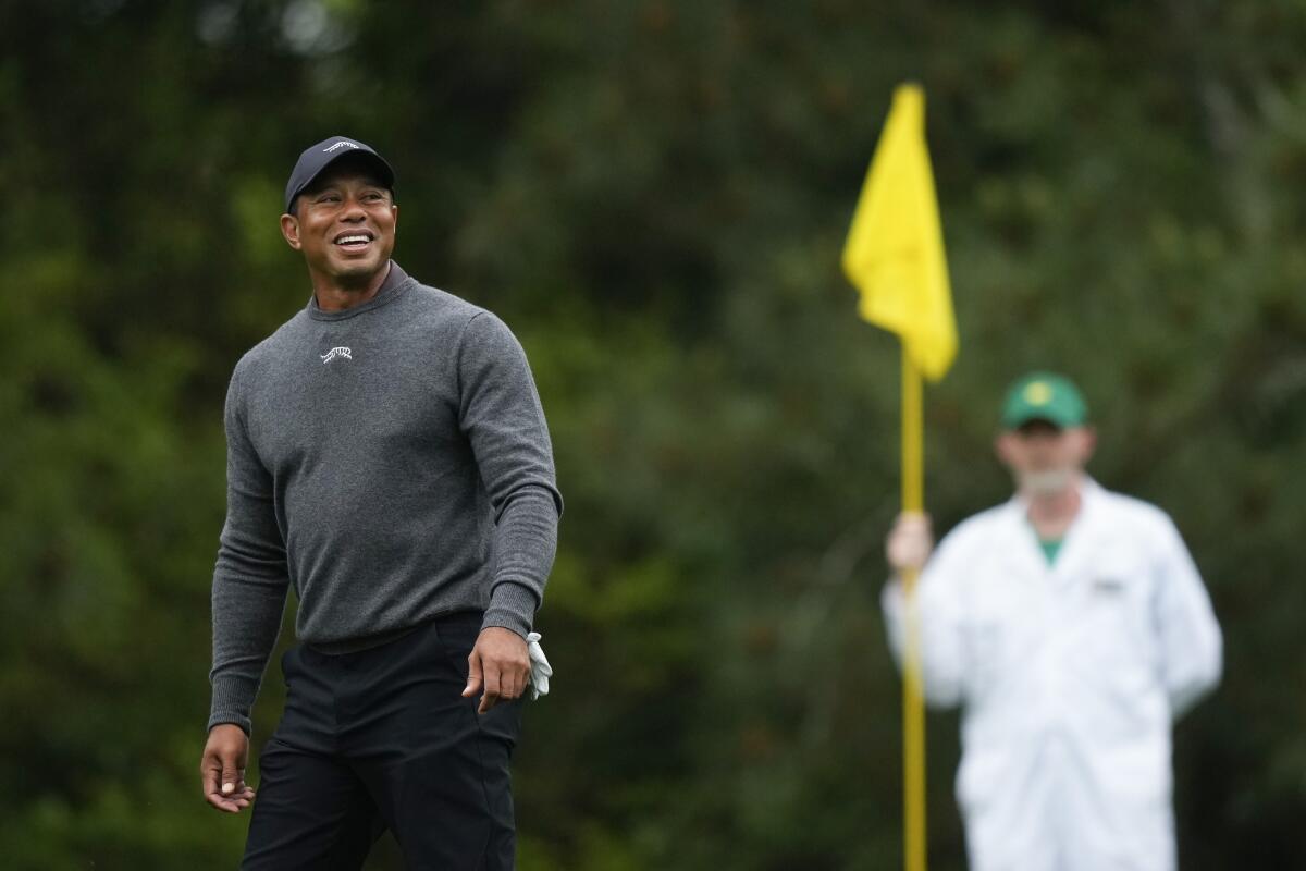 Tiger Woods smiles on on the fifth green during a practice round in preparation for the Masters on Tuesday.