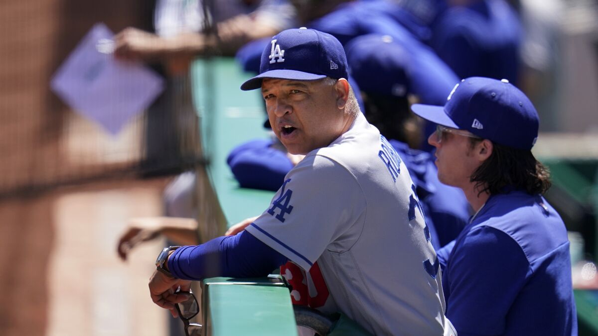 Dodgers manager Dave Roberts talks with an umpire during a game against the Pittsburgh Pirates on May 11.