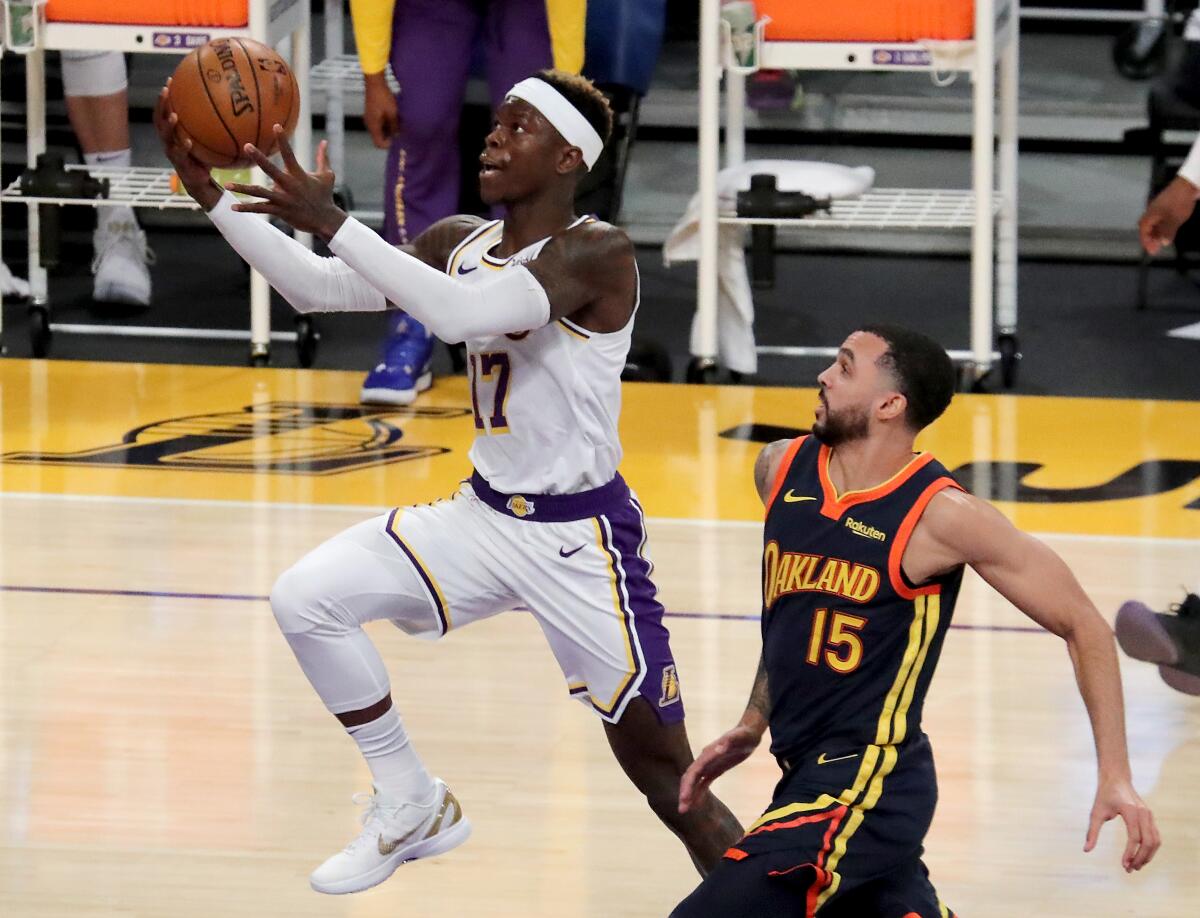 Lakers guard Dennis Schroder drives to the basket for a layup against Warriors guard Mychal Mulder.