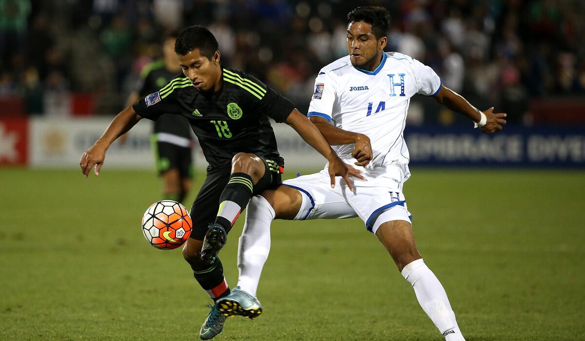 Mexico's Alfonso Tamay controls the ball against Honduras' Joshua Nieto during 2015 CONCACAF Olympic Qualifying on Wednesday.