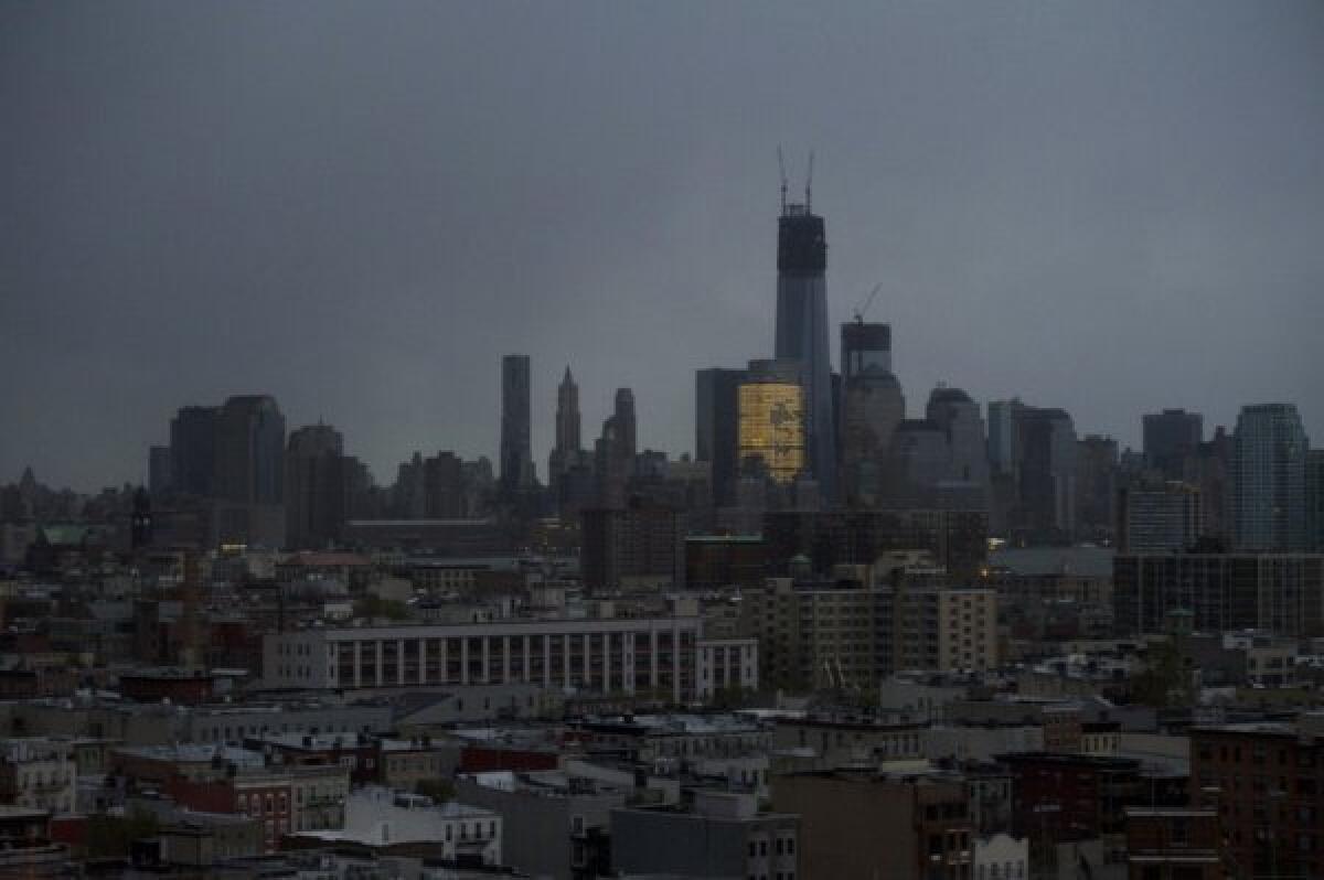 One World Trade Center and large portions of lower Manhattan and Hoboken, N.J., are seen without power from Jersey City, N.J. on Tuesday morning, the day after superstorm Sandy made landfall.