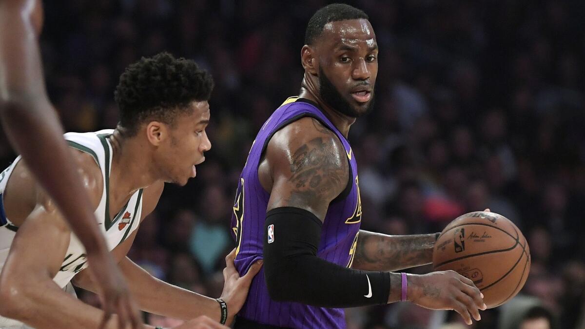Lakers forward LeBron James tries to work past Bucks forward Giannis Antetokounmpo during the first half of an NBA basketball game on March 1, 2019, at Staples Center.