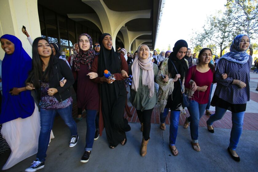Students lead a march at SDSU on Monday in response to a hate crime against a female Muslim student in a campus parking lot last week. About 400 people participated in the march and rally against intolerance.