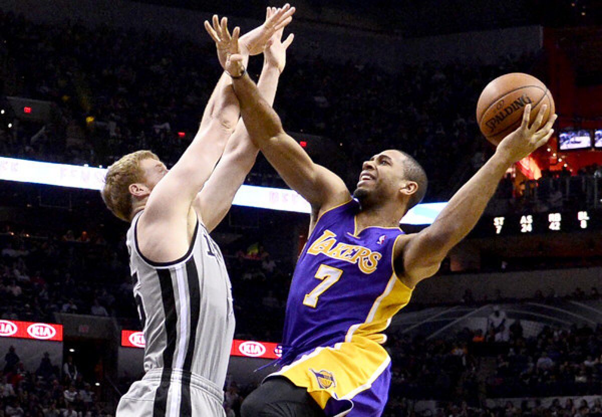 Lakers swingman Xavier Henry tries to score on a layup against Spurs forward Matt Bonner in the second half of their game Friday night in San Antonio.