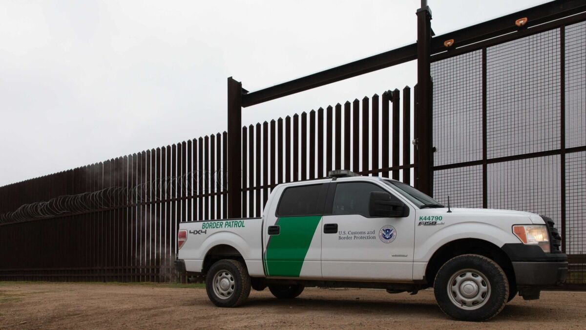 A U.S. Customs and Border Protection vehicle drives at the gate of the fence at the U.S.-Mexico border in McAllen, Texas, on Jan. 15.