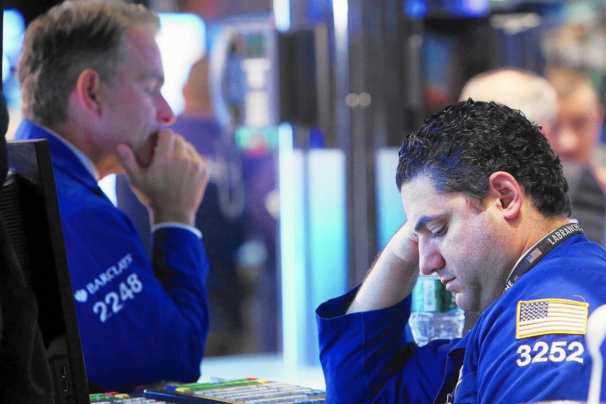 Traders work on the floor of the New York Stock Exchange during the biggest stock sell-off in two months. The Dow Jones industrial average closed down 264 points.