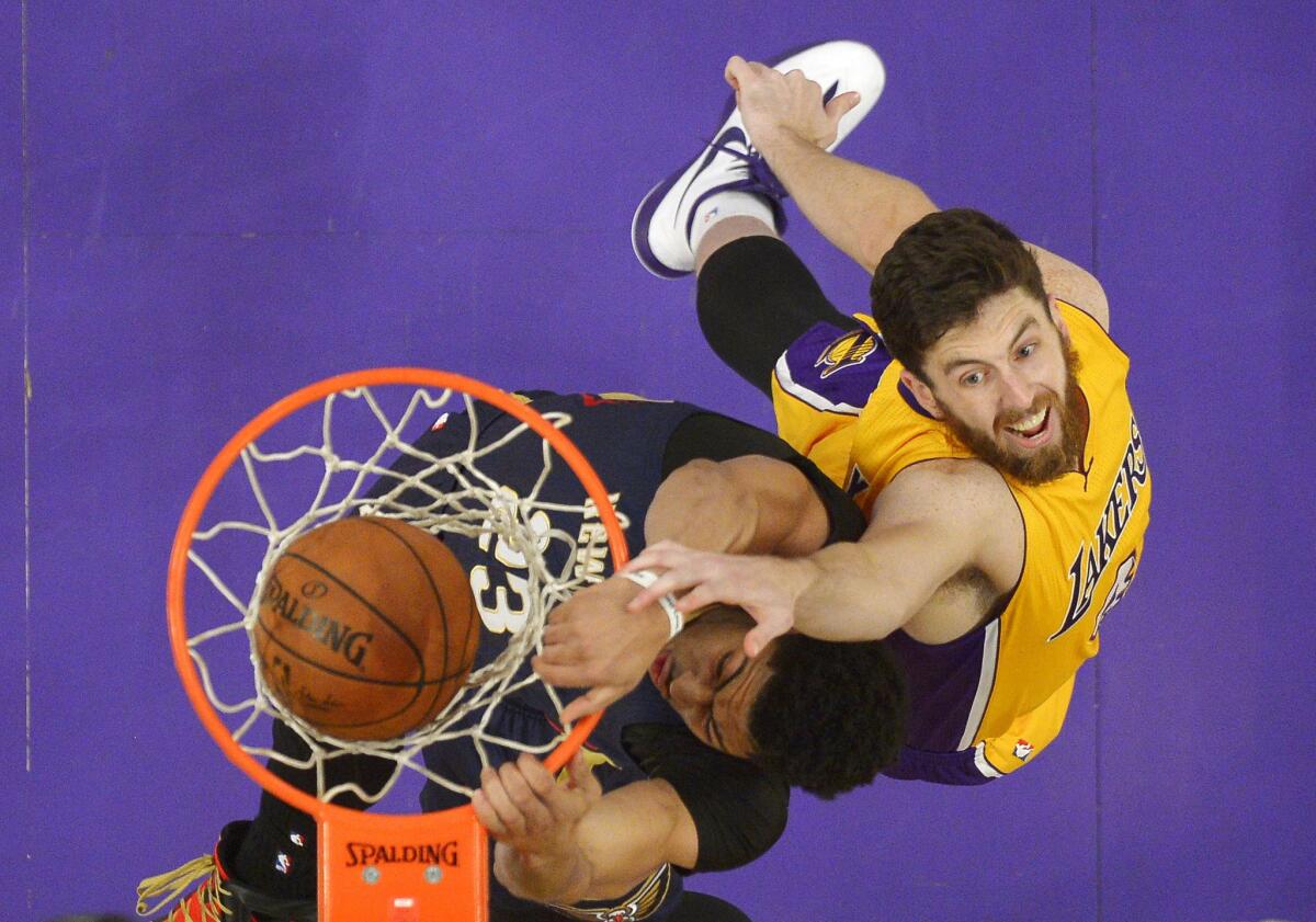 Lakers forward Ryan Kelly can't prevent Pelicans forward Anthony Davis from dunking during a game at Staples Center on April 1, 2015.