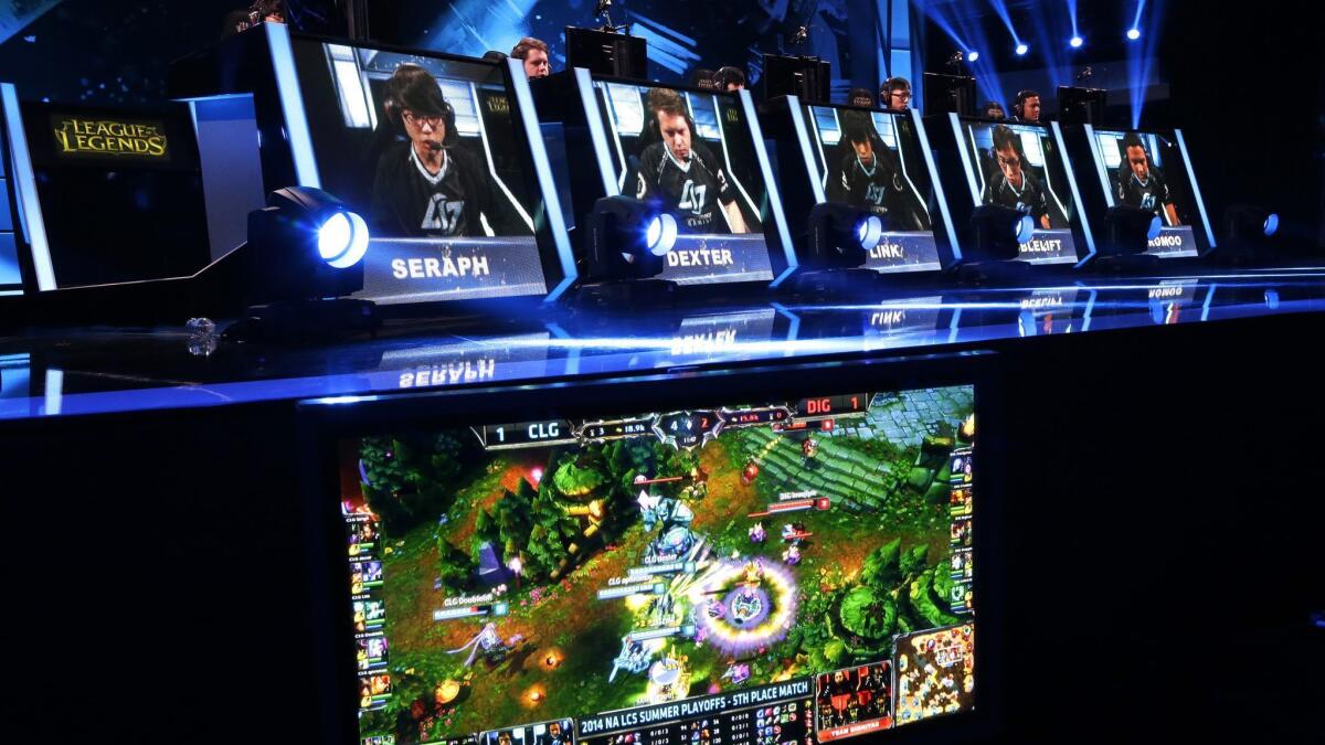 In this 2014 photo, the names and faces of gamers are shown as they compete in a round of the "League of Legends" championship series in Seattle.