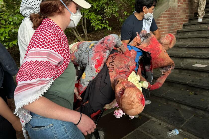 Demonstrators carry fake corpses during a pro-Palestinian protest Monday on the UCLA campus. Alene Tchekmedyian / Los Angeles Times