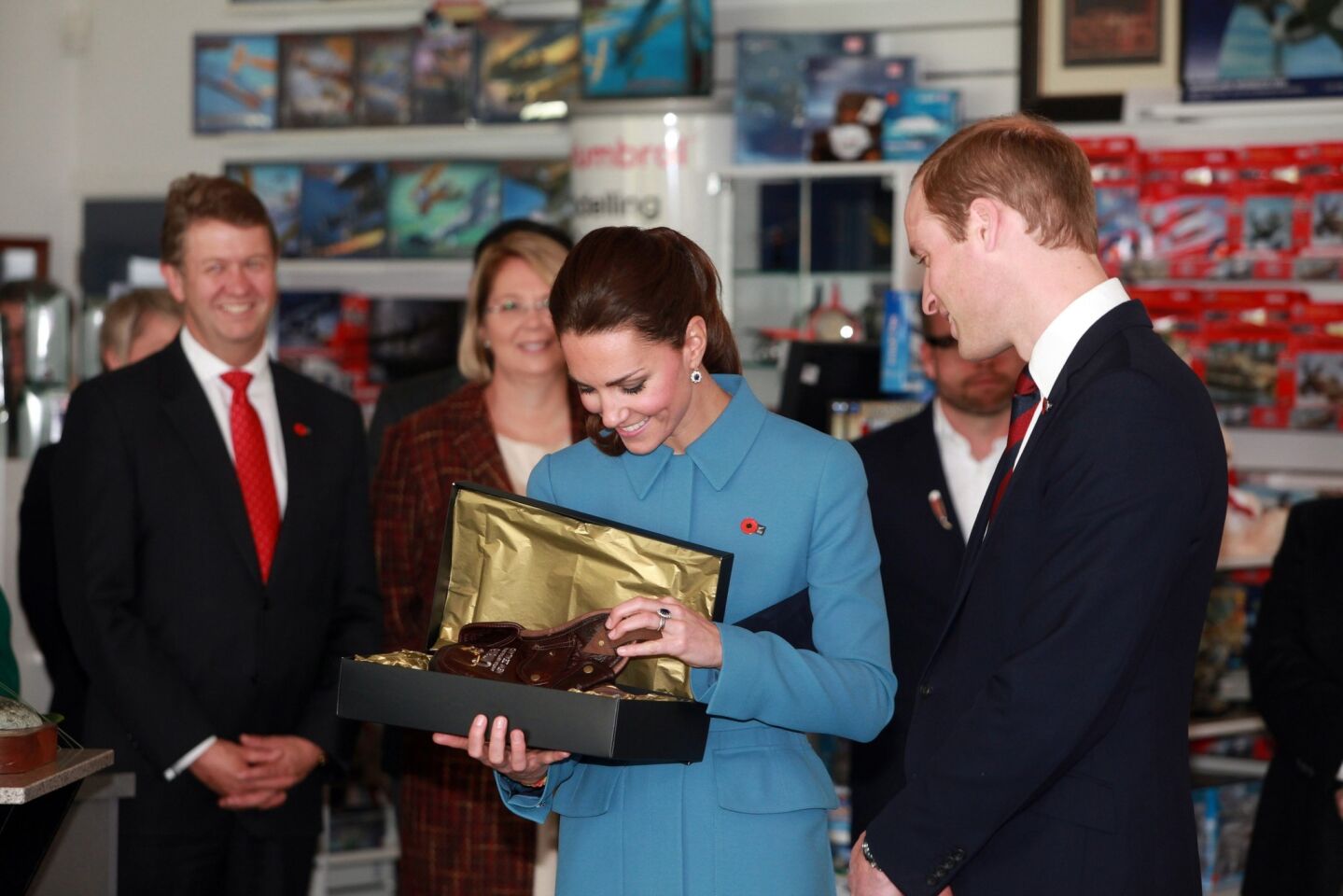 The duke and duchess receive a gift for Prince George during their visit to the "Knights of the Sky" exhibition at the Omaka Aviation Heritage Center in Blenheim, New Zealand.
