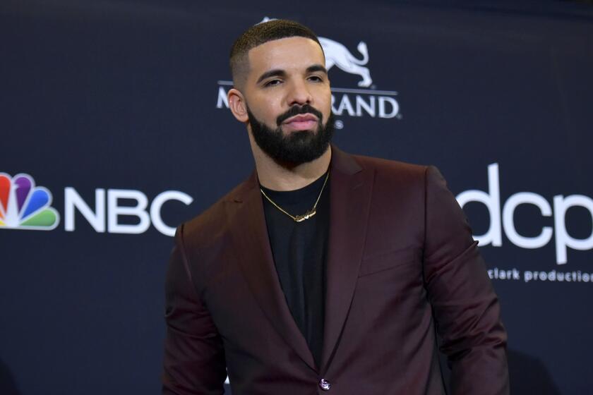 Rapper Drake in a burgundy suit jacket