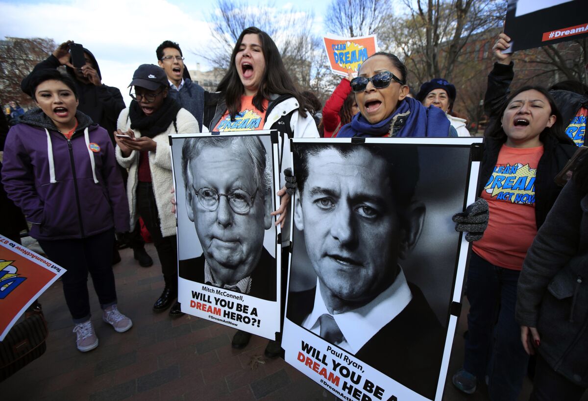 Amanda Bayer, left with banner, and Marisol Maqueda, right with banner, join a rally in support of so-called Dreamers outside the White House.