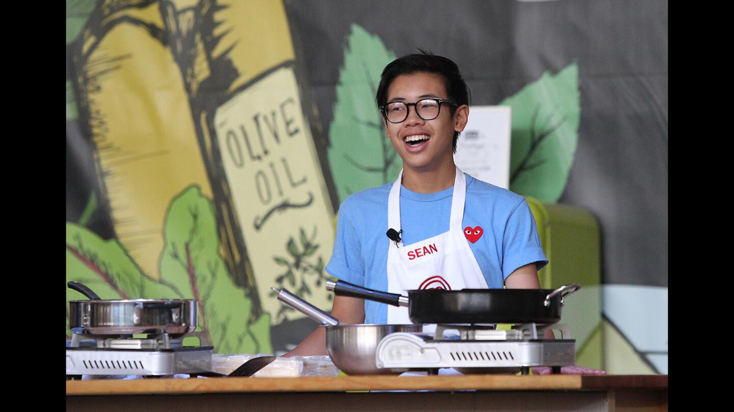 Youth chef and Fountain Valley resident Sean Le reacts to a question as he battles fellow youth chef Mason Partak to see who can make the supreme burger at the OC Fair on Thursday.