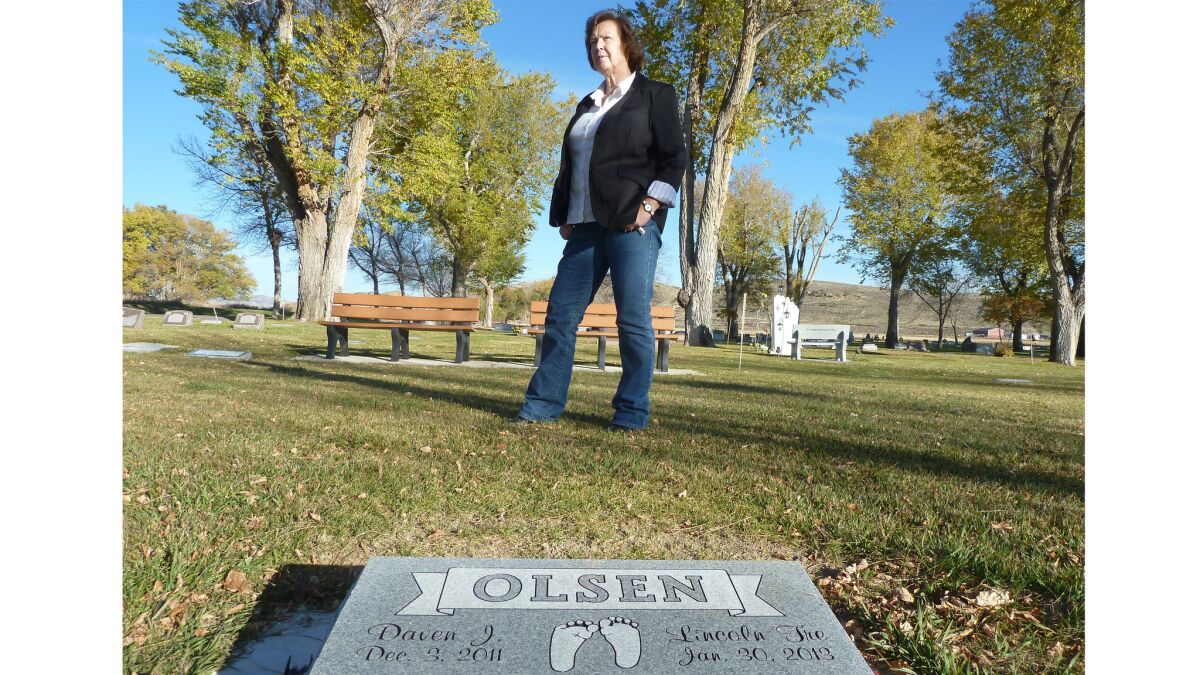 Midwife Donna Young stands near grave of a baby who died last year in the oil-drilling boomtown of Vernal, in northeast Utah. She has alerted health officials to an apparent increase in infant mortality.