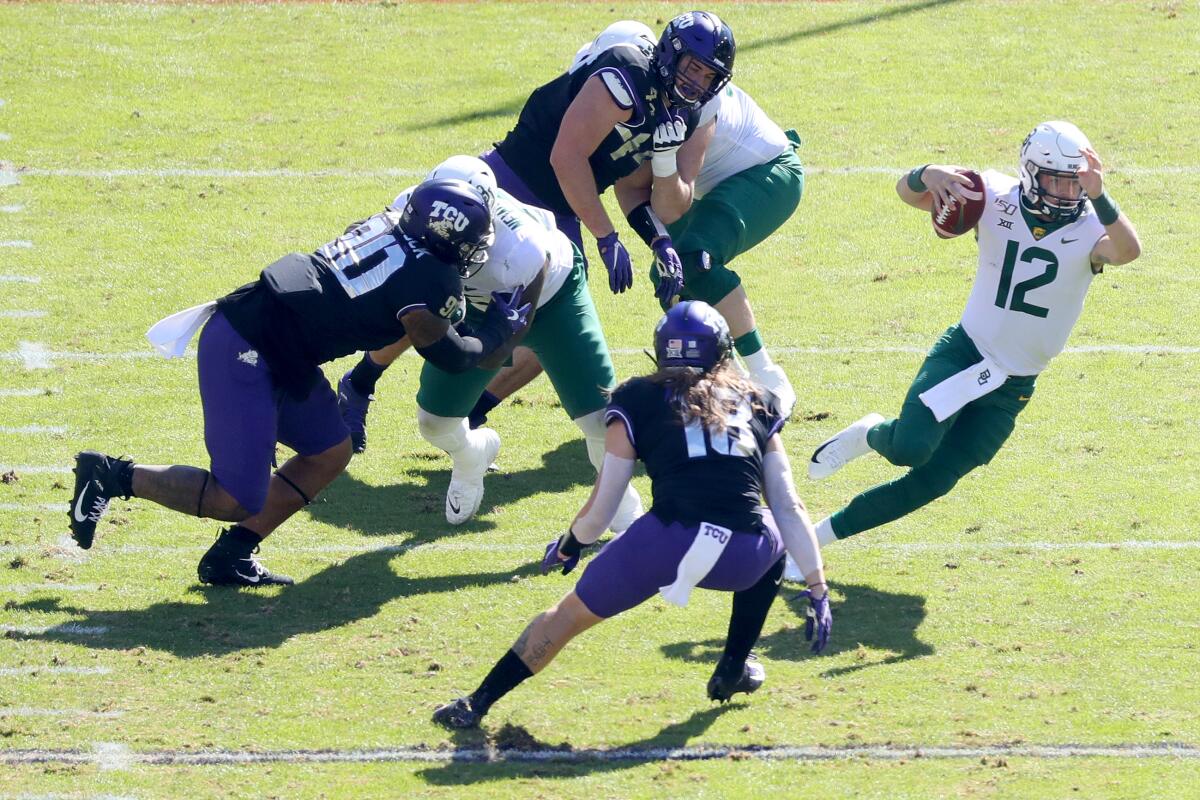 Baylor quarterback Charlie Brewer scrambles with the ball against TCU on Saturday.