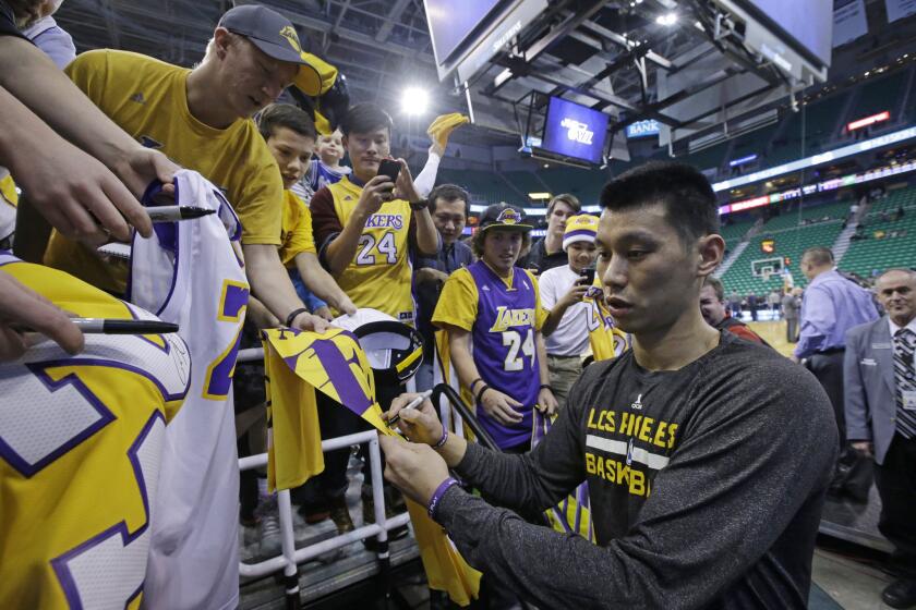 Lakers guard Jeremy Lin signs autographs before Friday night's game at Utah.
