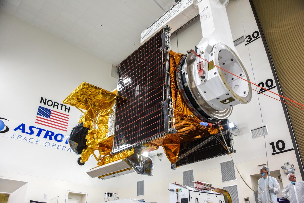 The Surface Water and Ocean Topography satellite is moved into a transport container at Vandenberg Space Force Base.