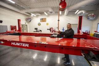 Orange, CA - November 30: German Zarate, a deputy juvenile correctional officer, shows off the new auto shop which is part of the new Multipurpose Rehabilitation Center at the Orange County Juvenile Hall on Wednesday, Nov. 30, 2022 in Los Angeles, CA. (Scott Smeltzer / Los Angeles Times)
