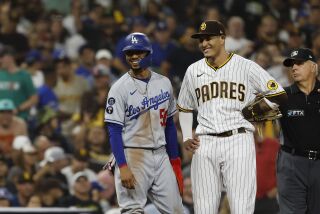 Los Angeles Dodgers' Mookie Betts was stranded at third base in the seventh inning as San Diego Padres' Manny Machado 