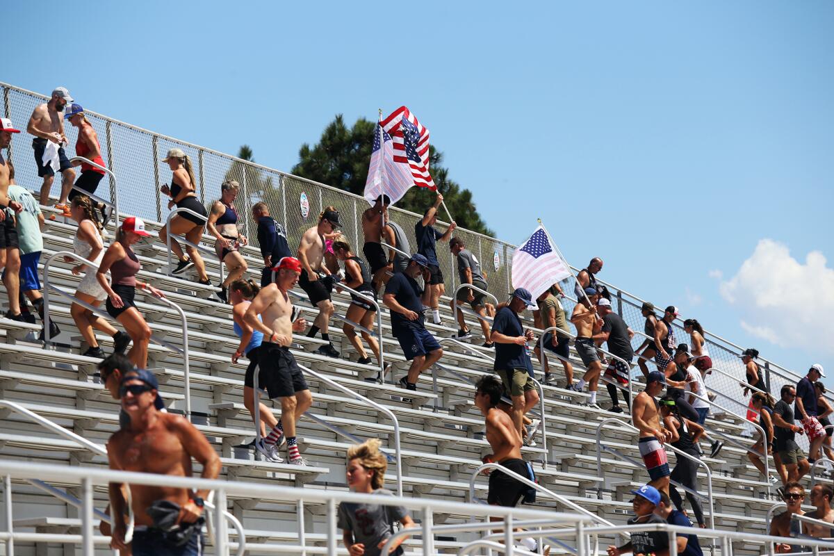 Participants run 110 flight of stairs Sunday during a 9/11 Honor Challenge at Sheue Field at Huntington Beach High School.