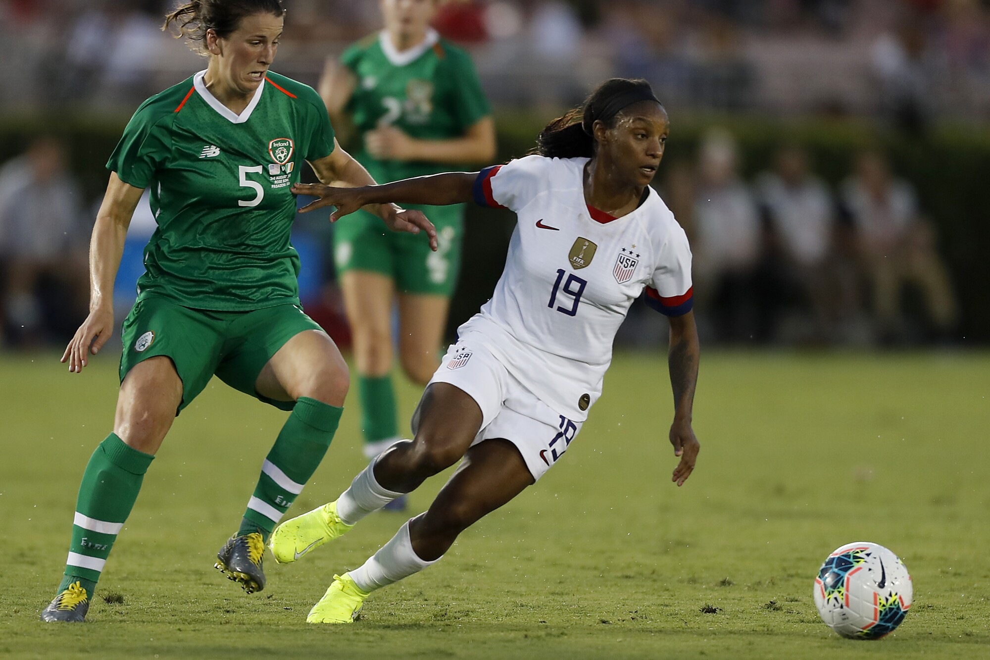 U.S. defender Crystal Dunn dribbles past Ireland defender Niamh Fahney during a match at the Rose Bowl in Pasadena. 