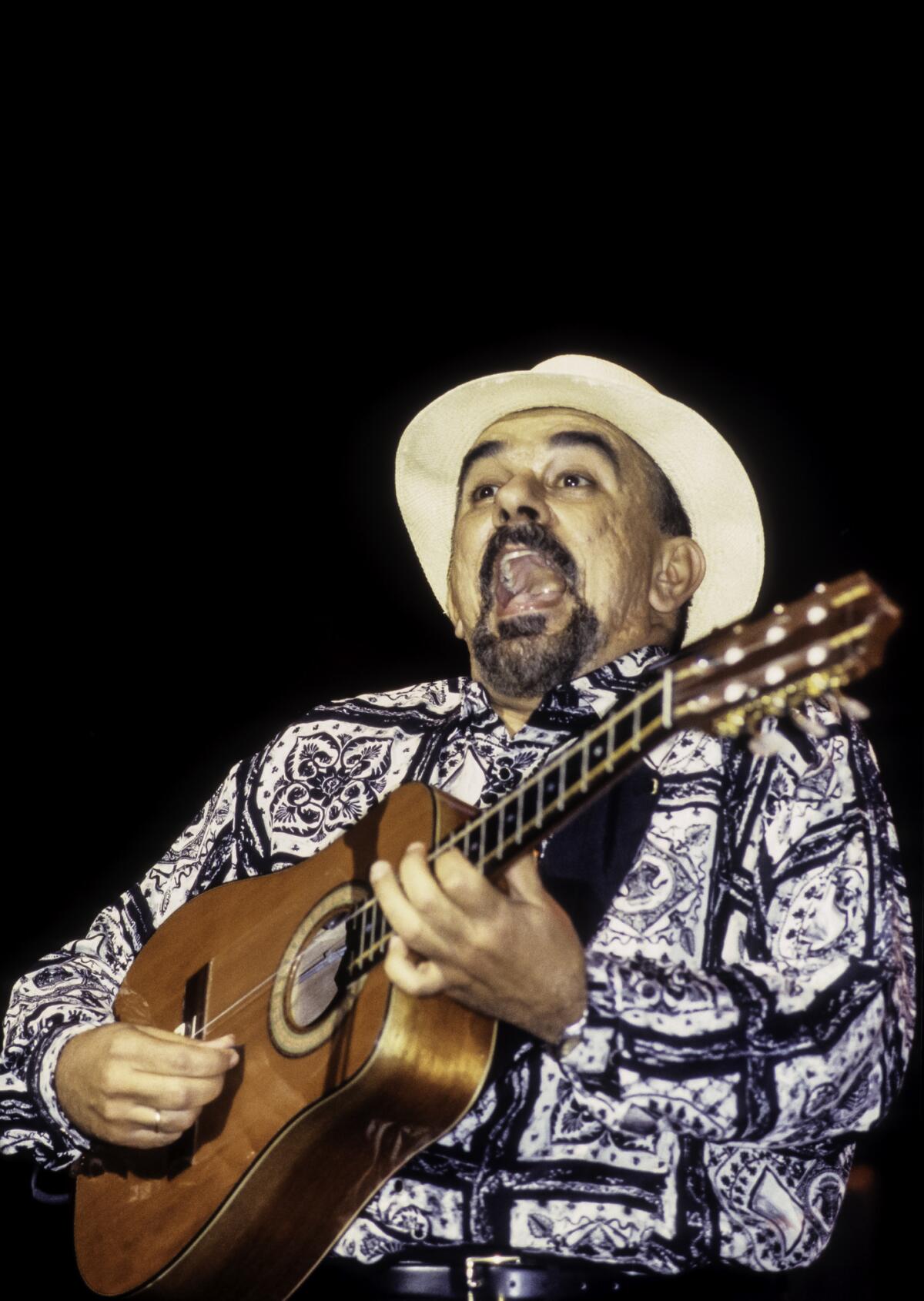 Cuba's Pancho Amat, seen in 1998 playing the tres (a six-string Cuban guitar) with the band Cubanismo during the JVC Jazz Festival's 'Habana, New York' concert at Hammerstein Ballroom.
