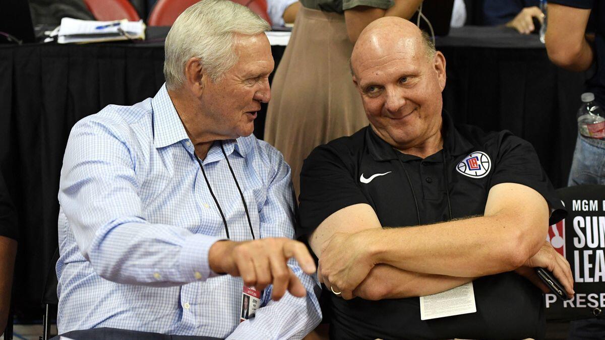Clippers consultant Jerry West and team owner Steve Ballmer talk at a July 6 NBA Summer League game between the Dallas Mavericks and the Phoenix Suns in Las Vegas.