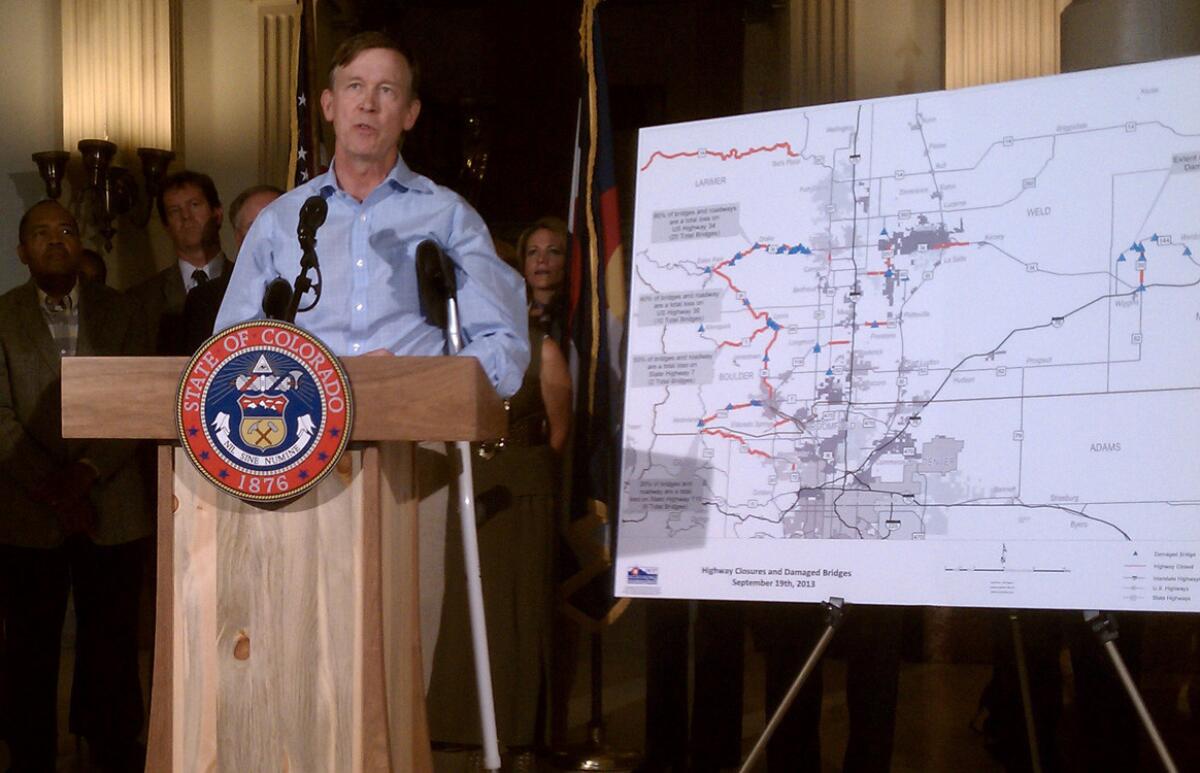 Colorado Gov. John Hickenlooper talks at a Denver news conference about the aftermath of last week's historic rains.
